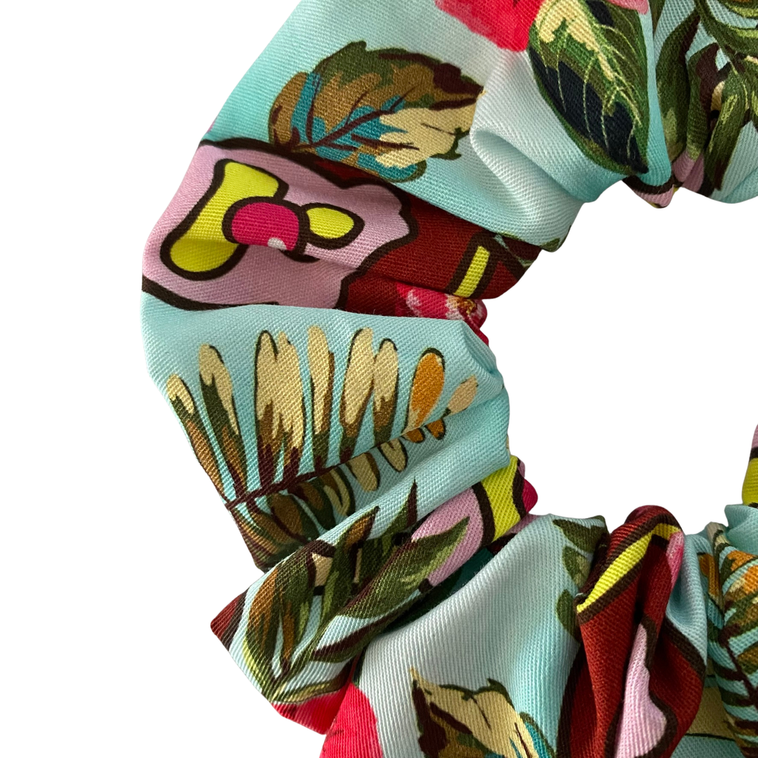 Colorful scrunchie with floral pattern on a white background.