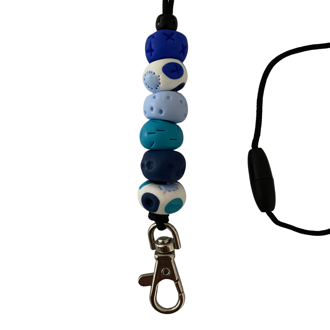 Handmade polymer clay lanyard with six hand-rolled beads in blue colours. Threaded on a nylon cord with a breakaway safety clasp and a silver-plated clip.