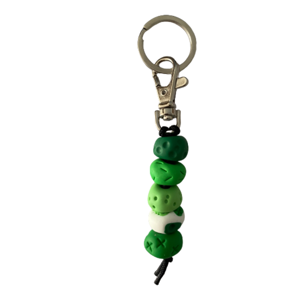 Handmade polymer clay keyring with five hand-rolled beads in green colours, attached to a silver clasp and split ring.