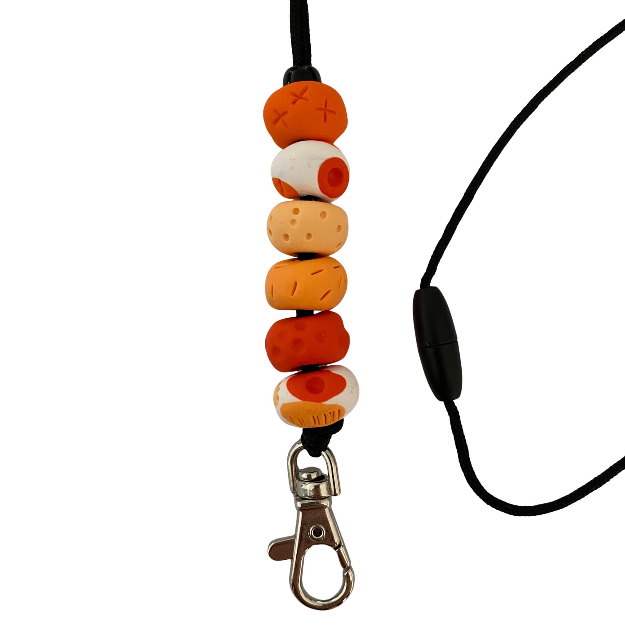 Handmade polymer clay lanyard with six hand-rolled beads in orange colours. Threaded on a nylon cord with a breakaway safety clasp and a silver-plated clip.