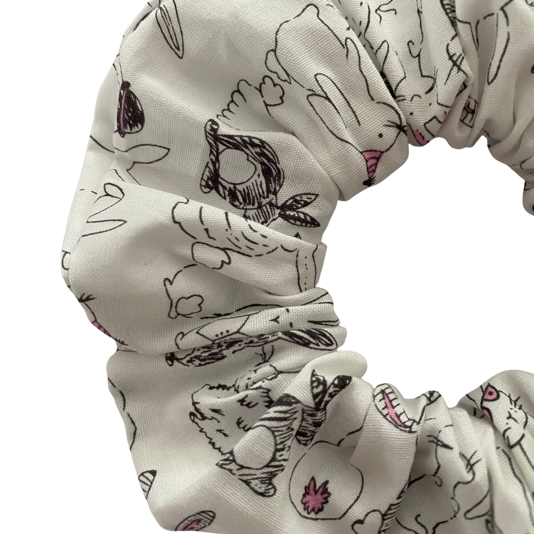 A white fabric scrunchie featuring adorable rabbit illustrations.