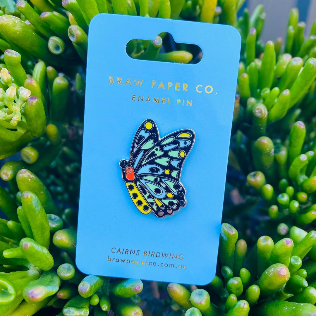 Cairns Birdwing Butterfly enamel pin on blue backing card.