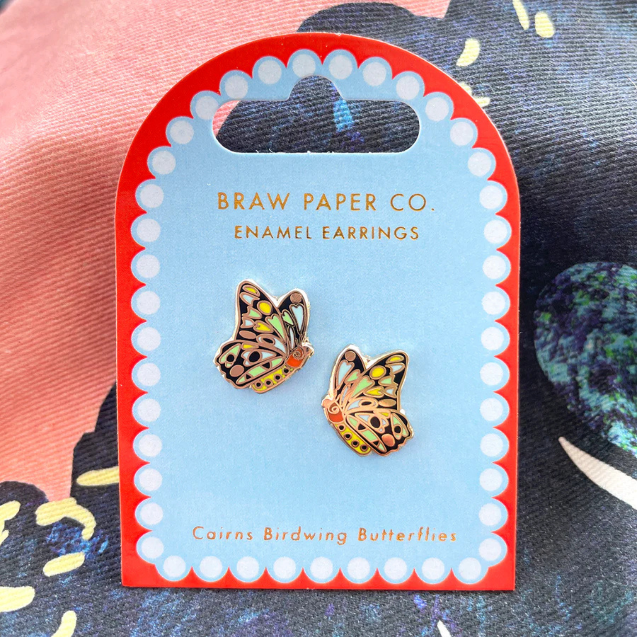 A pair of Cairns Birdwing Butterly enamel stud earrings on backing card.