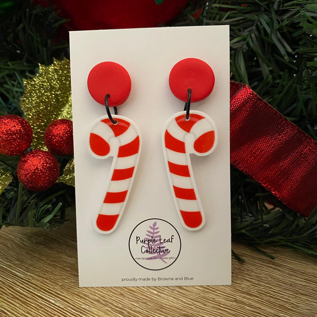 Candy cane earrings on a red stud topper on a white card.