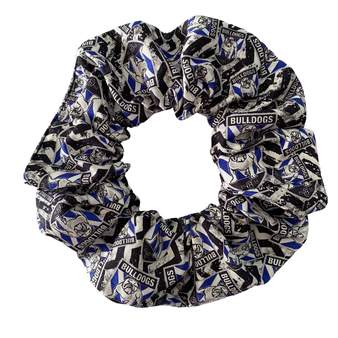 A scrunchie hair tie handmade with cotton woven fabric with images of the Canterbury-Bankstown Bulldogs rugby league team.