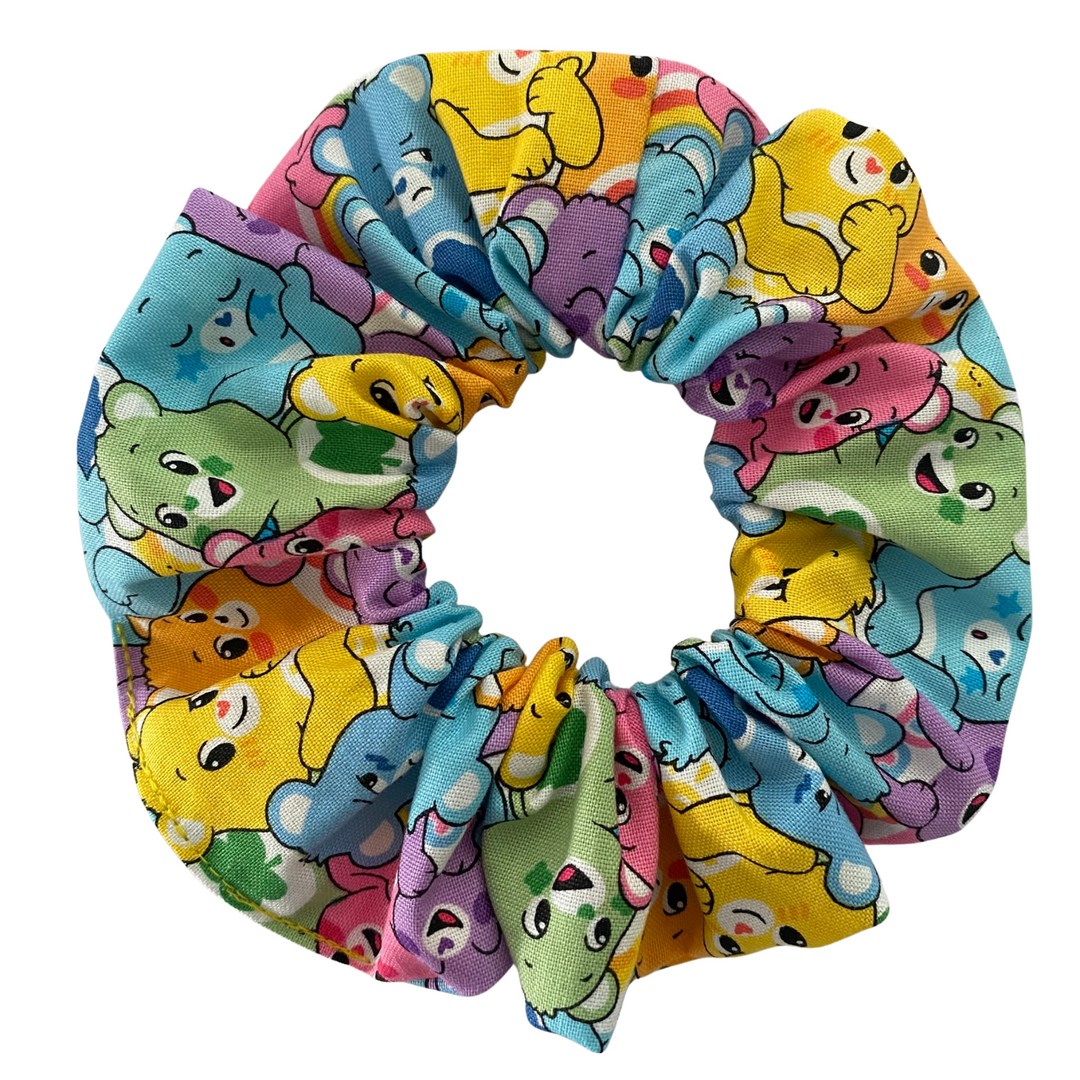 Colourful scrunchie with Care Bears characters pattern on a white background.
