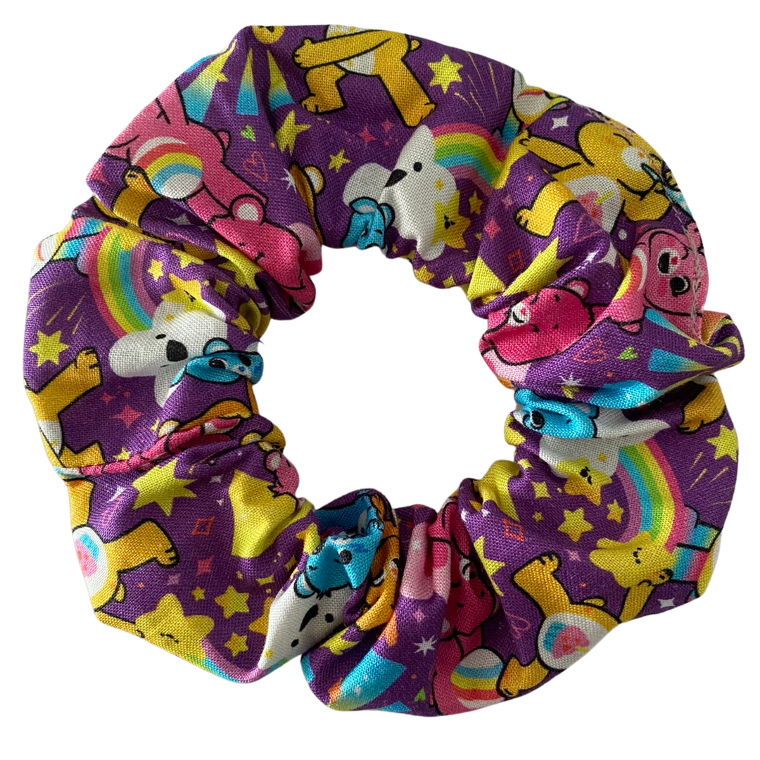Colourful mix of care bears on a purple scrunchie.