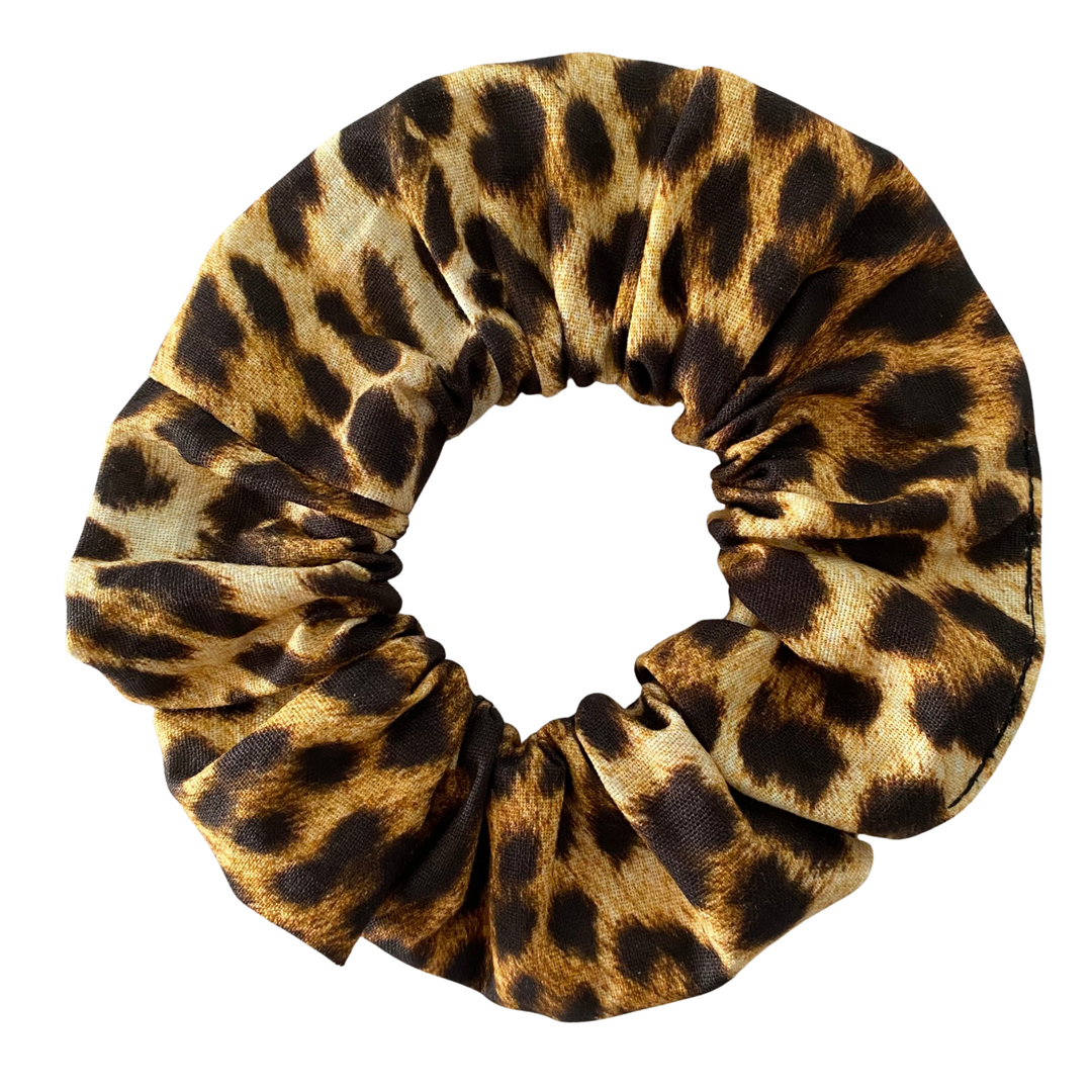Leopard print scrunchie on a white background.
