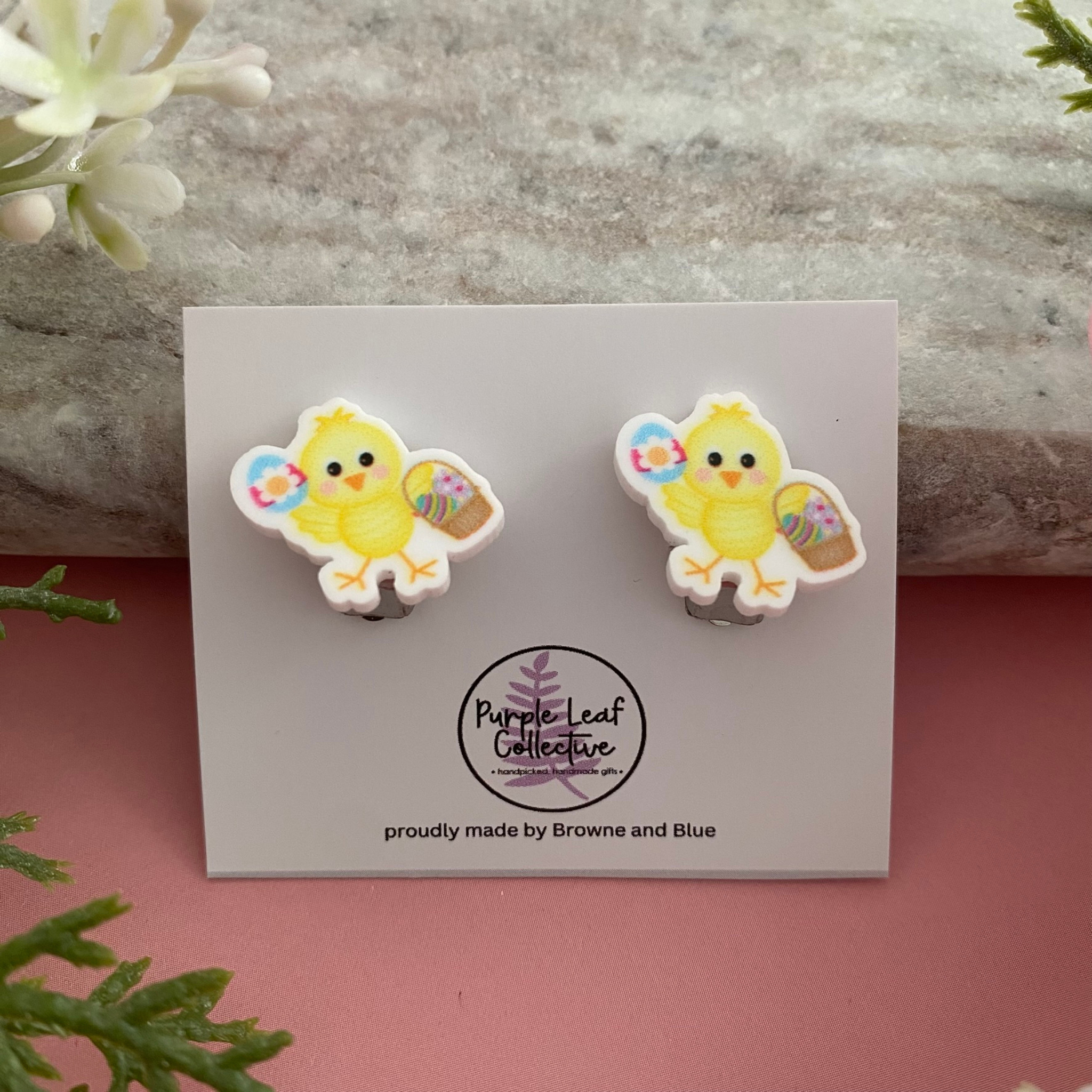Easter clip-on earrings featuring a sweet yellow chick holding a basket of colourful Easter Eggs.