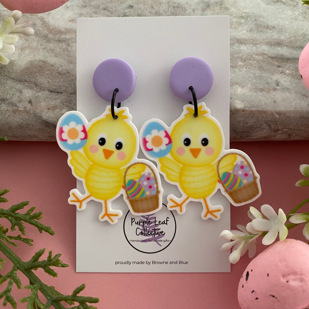 Easter dangle earrings featuring a sweet yellow chick holding a basket of colourful Easter Eggs.