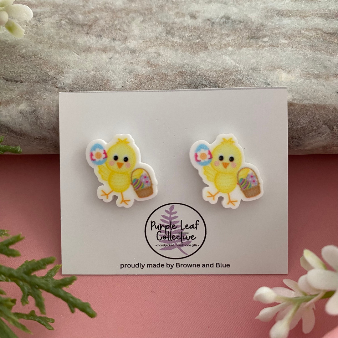 Easter stud earrings featuring a sweet yellow chick holding a basket of colourful Easter Eggs.
