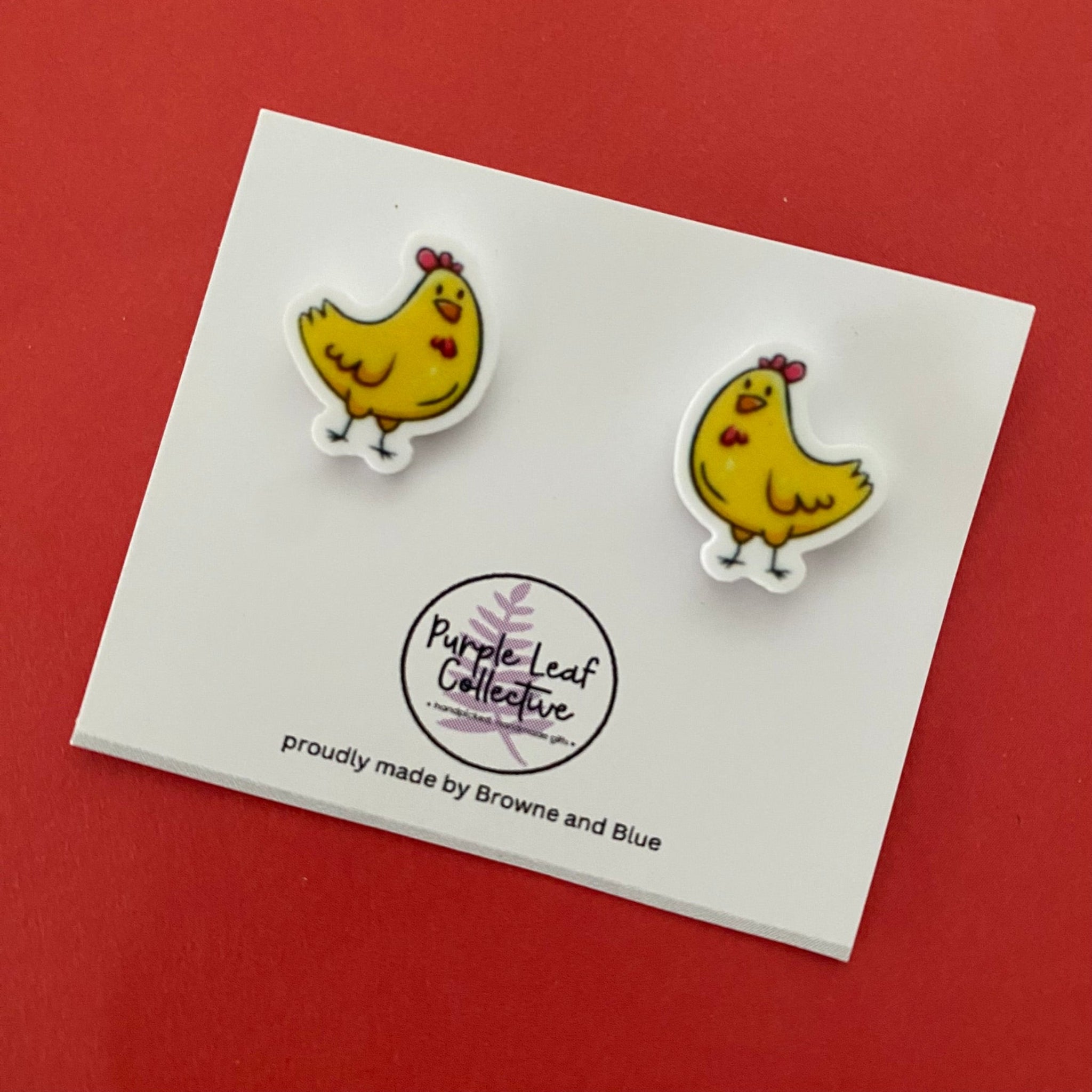 A pair of yellow chicken novelty stud earrings. Hypoallergic Surgical Steel Posts. Printed Acrylic. Approx 15mm.