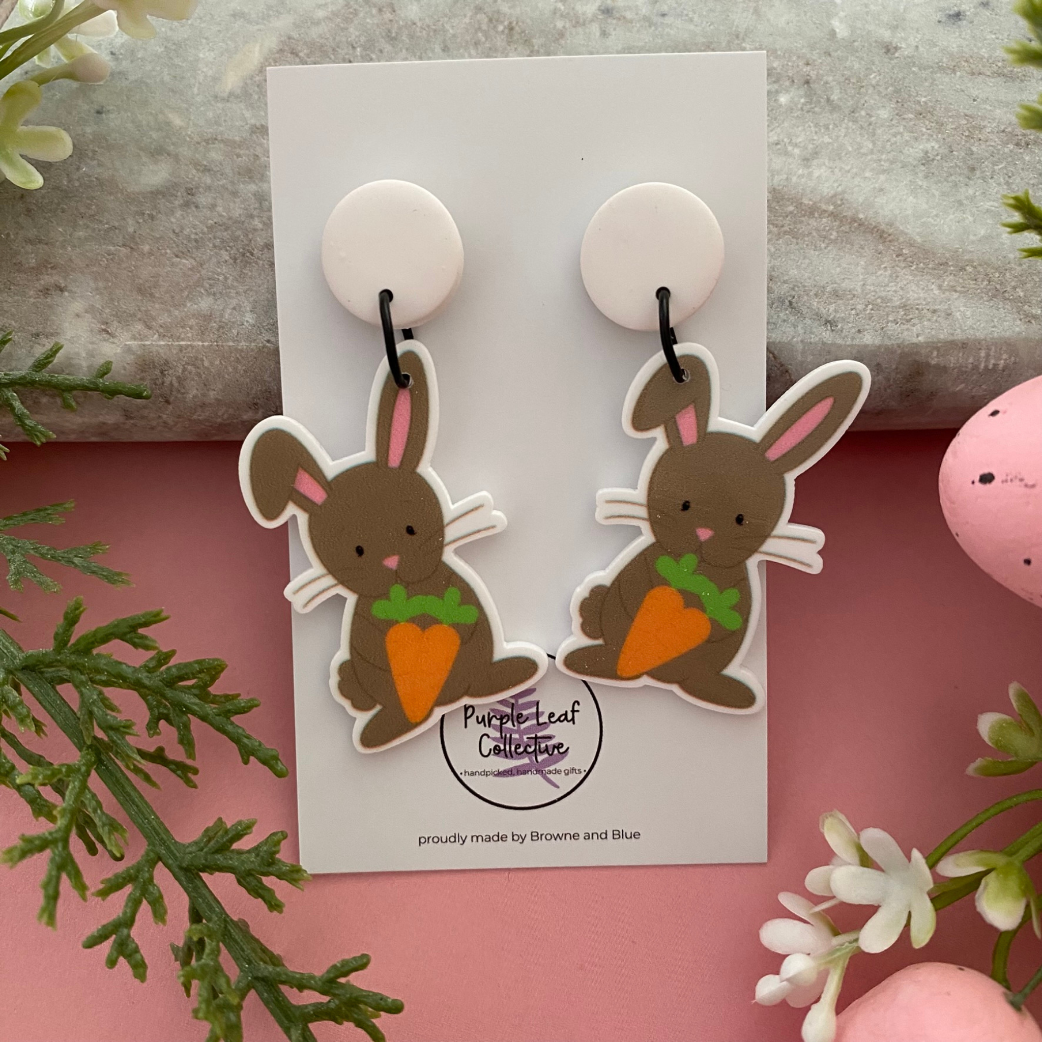 Handmade Easter dangle earrings featuring a chocolate-coloured rabbit holding an orange carrot.
