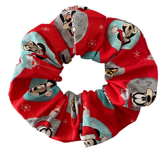 Red scrunchie with Mickey, Minnie, Donald, Daisy, Goofy character pattern on a white background.
