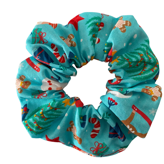Christmas themed scrunchie on a aqua blue fabric.