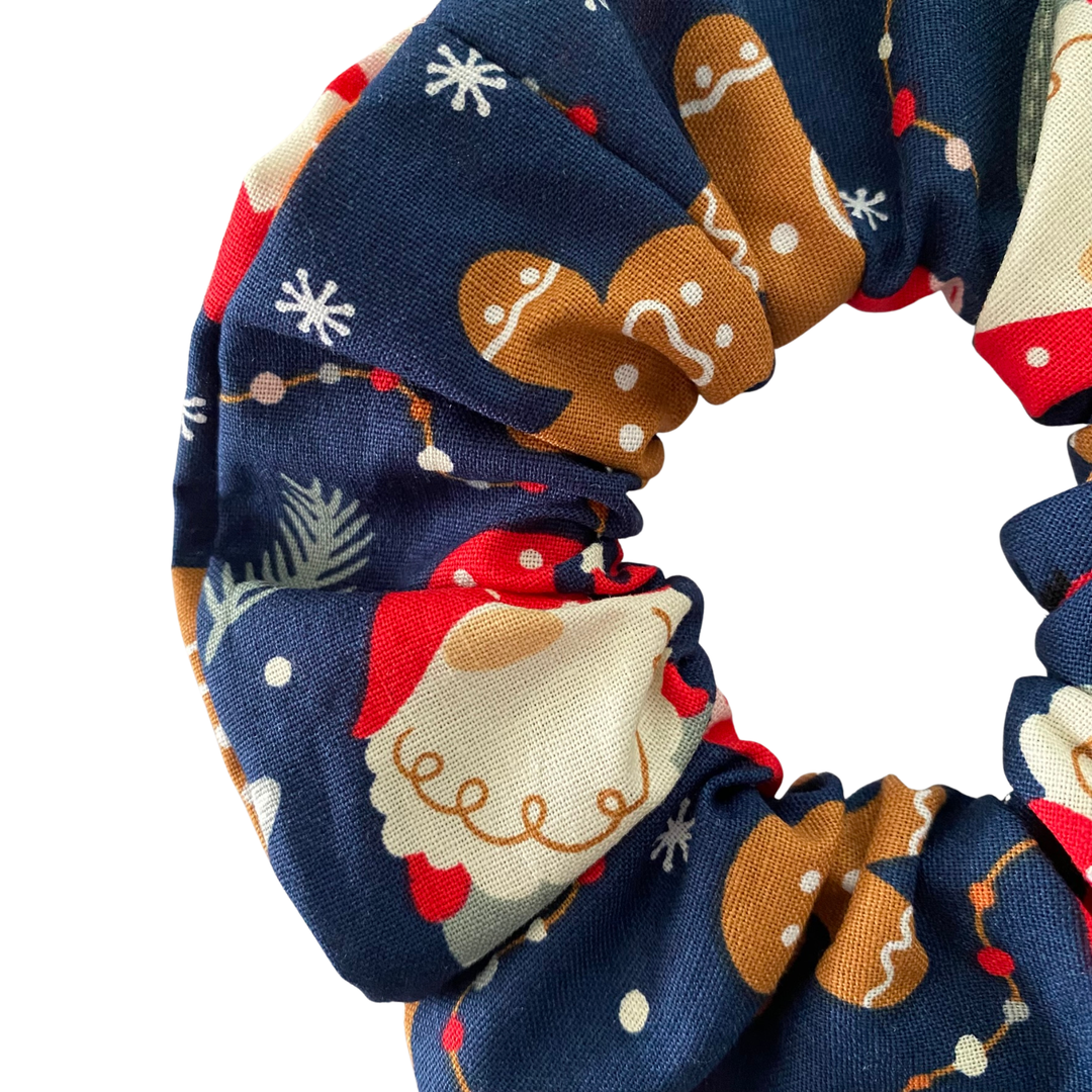 Festive images of gnomes and gingerbread men on a dark blue fabric.