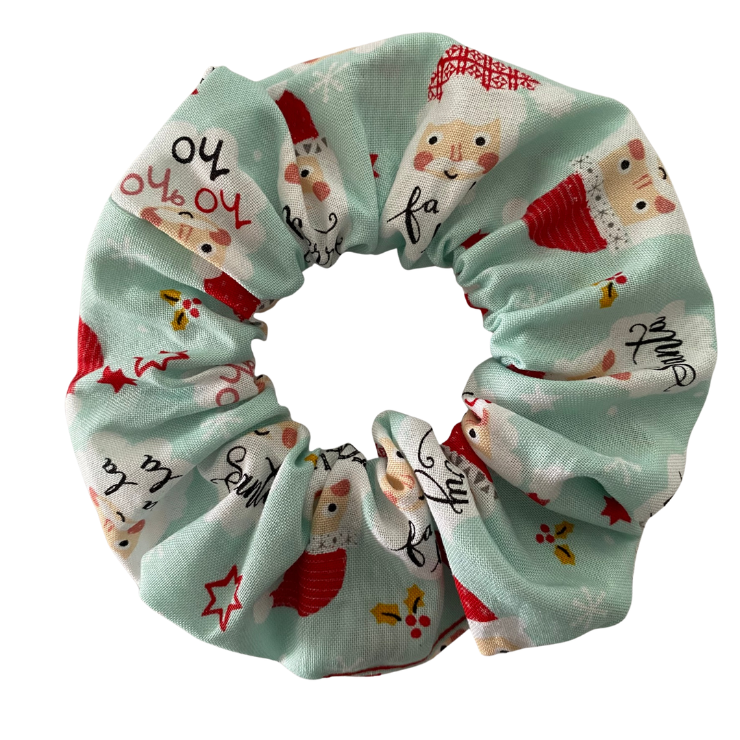 Scrunchie with Santa Claus pattern on a light blue background.