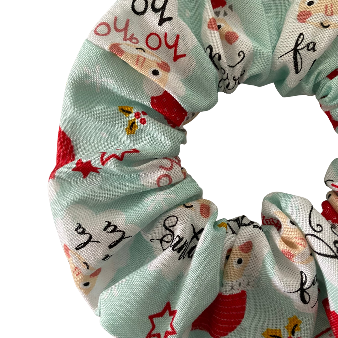 Scrunchie with festive design featuring Santa Claus on a light blue background.