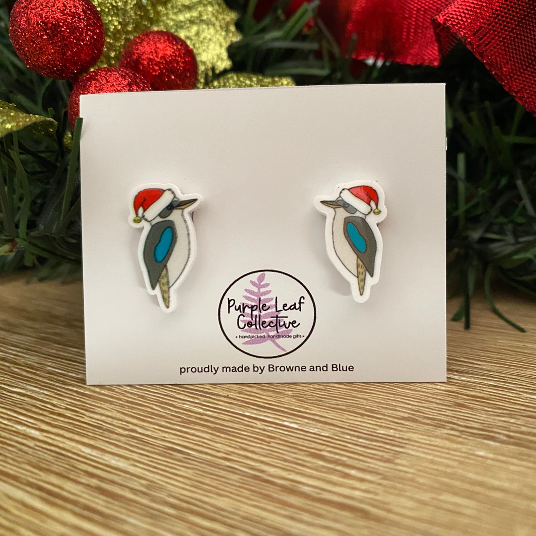 Kookaburra earrings on a card with 'Purple Leaf Collective' branding, set against a festive background.