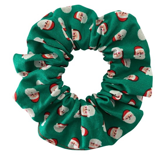Green scrunchie with Santa Claus face pattern on a white background.