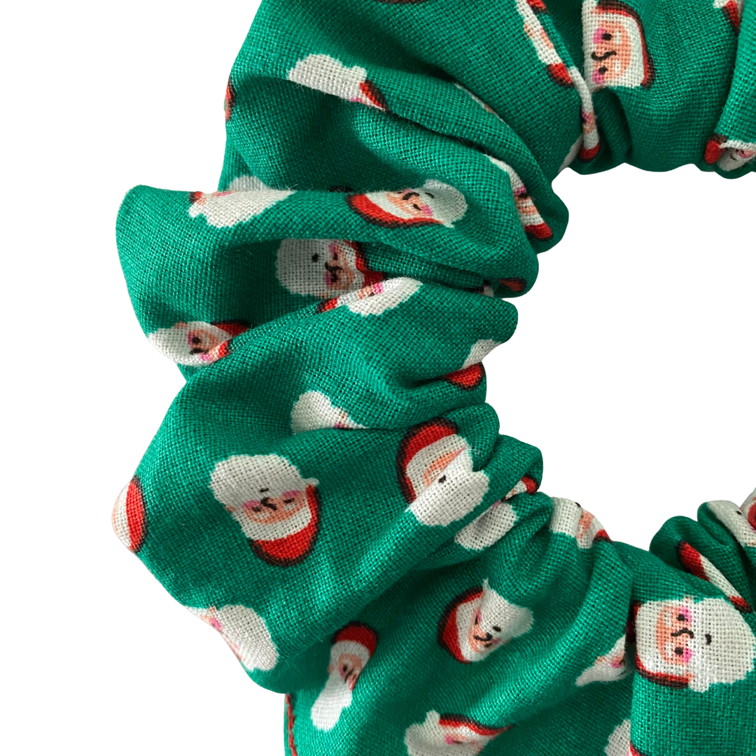 Santa Claus face pattern on a green scrunchie.