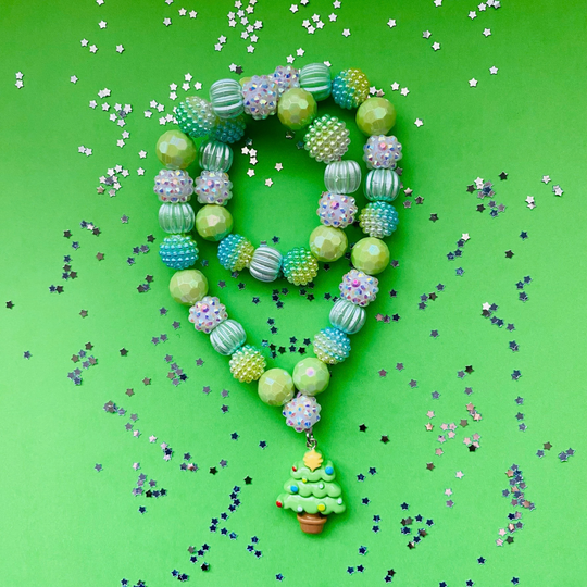 A doubled over beaded necklace with a Christmas tree charm, featuring light green, blue and iridescent beads.