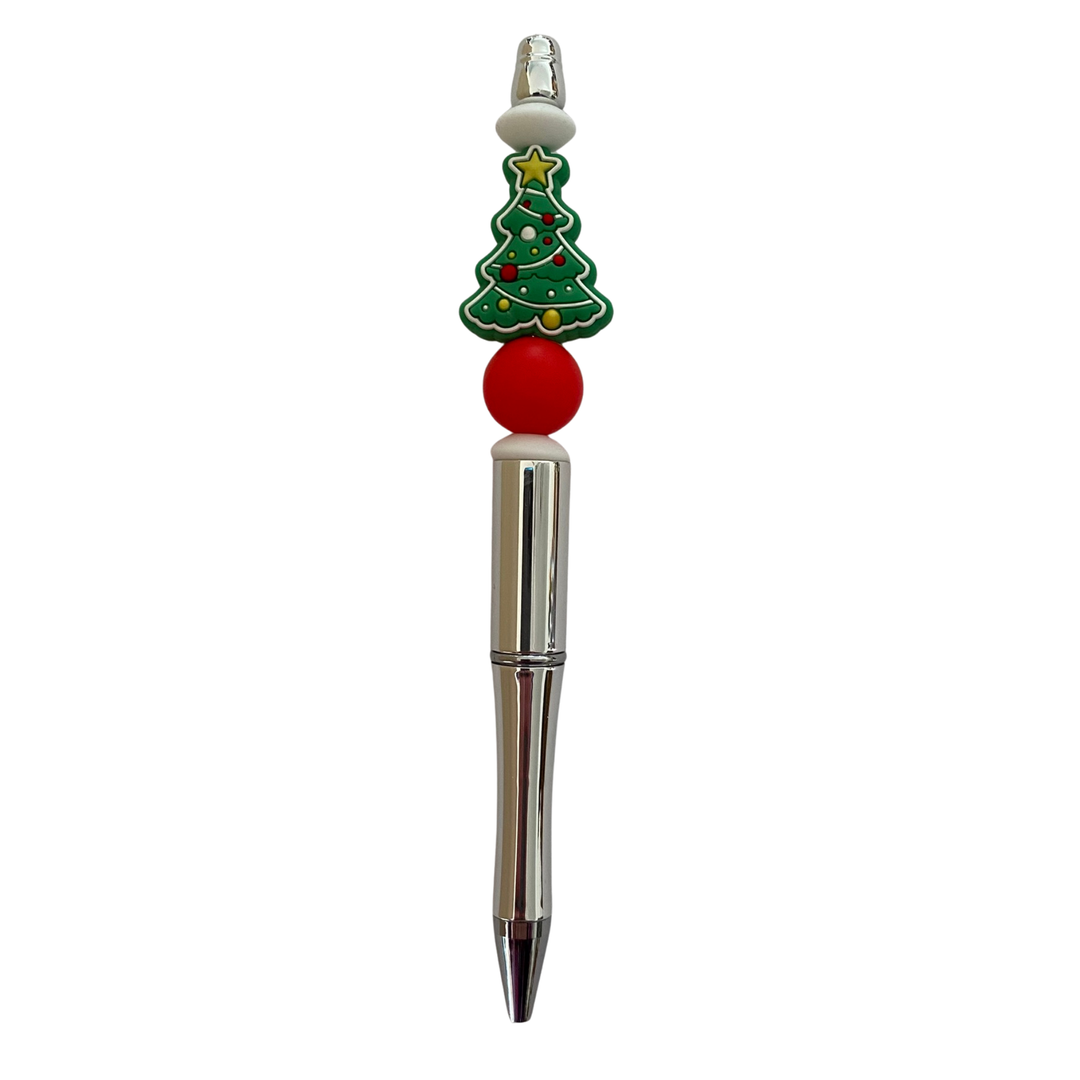 Pen with a Christmas tree design on top against a white background.