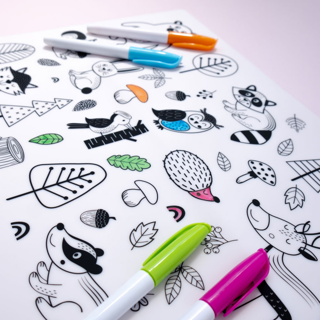 A picture of the Forest colour-in silicone placemat with images of delightful forest-inspired scenes, complete with woodland creatures, branches, and leaves.