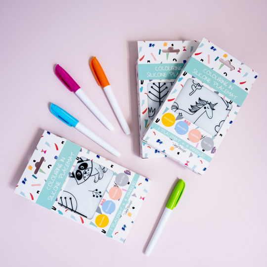 An image of the packaged Unicorn colour in silicone placemat and 4 nontoxic markers.