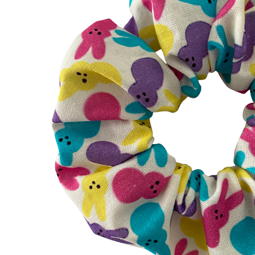 Scrunchie with colourful bunnies on a white fabric.