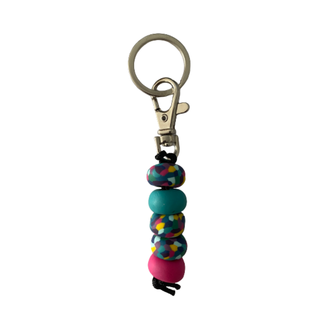 Handmade polymer clay keyring featuring five hand-rolled beads in raspberry, turquoise and multicoloured designs, attached to a silver clasp.