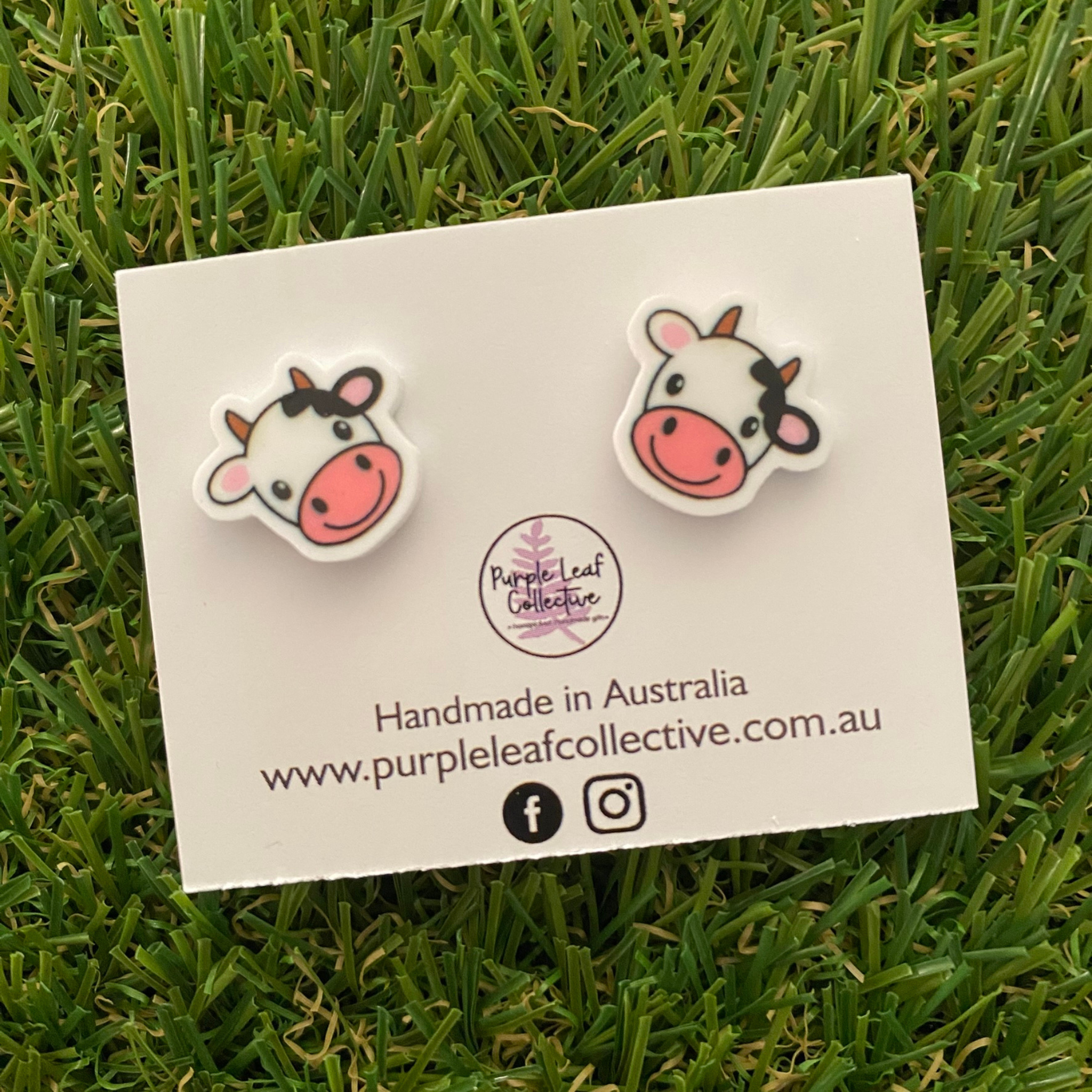 Pair of cow face shaped earrings.
