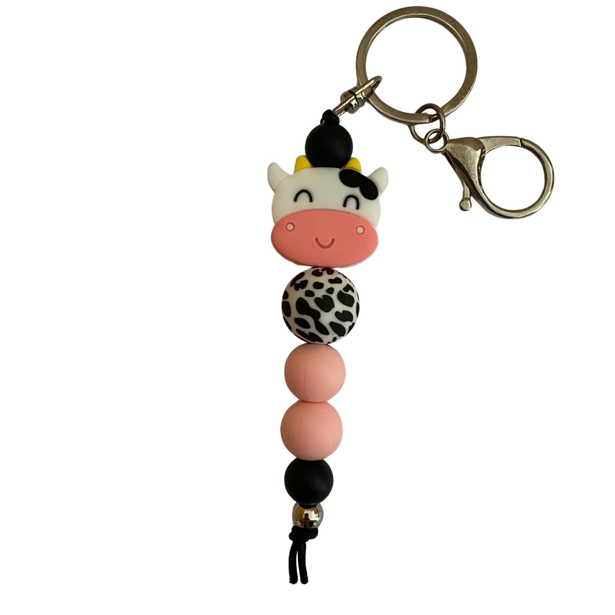 A keyring with a cow head silicone bead and other coloured round silicone beads.