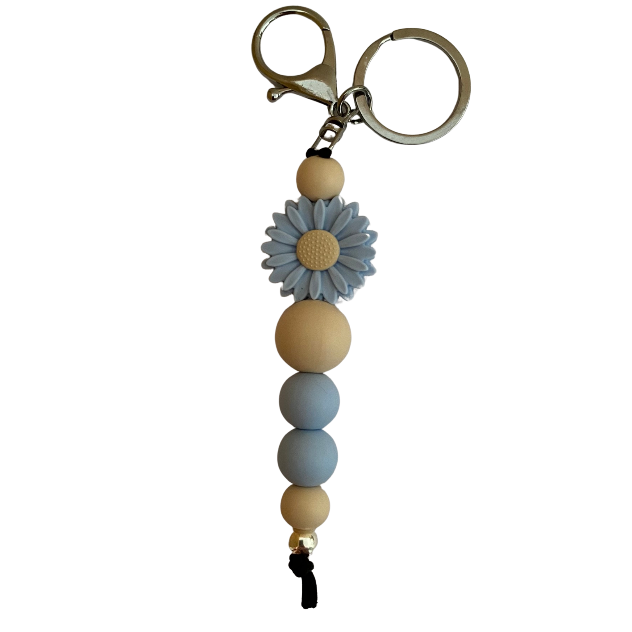 A keyring with a baby blue silicone daisy and other assorted silicone beads.