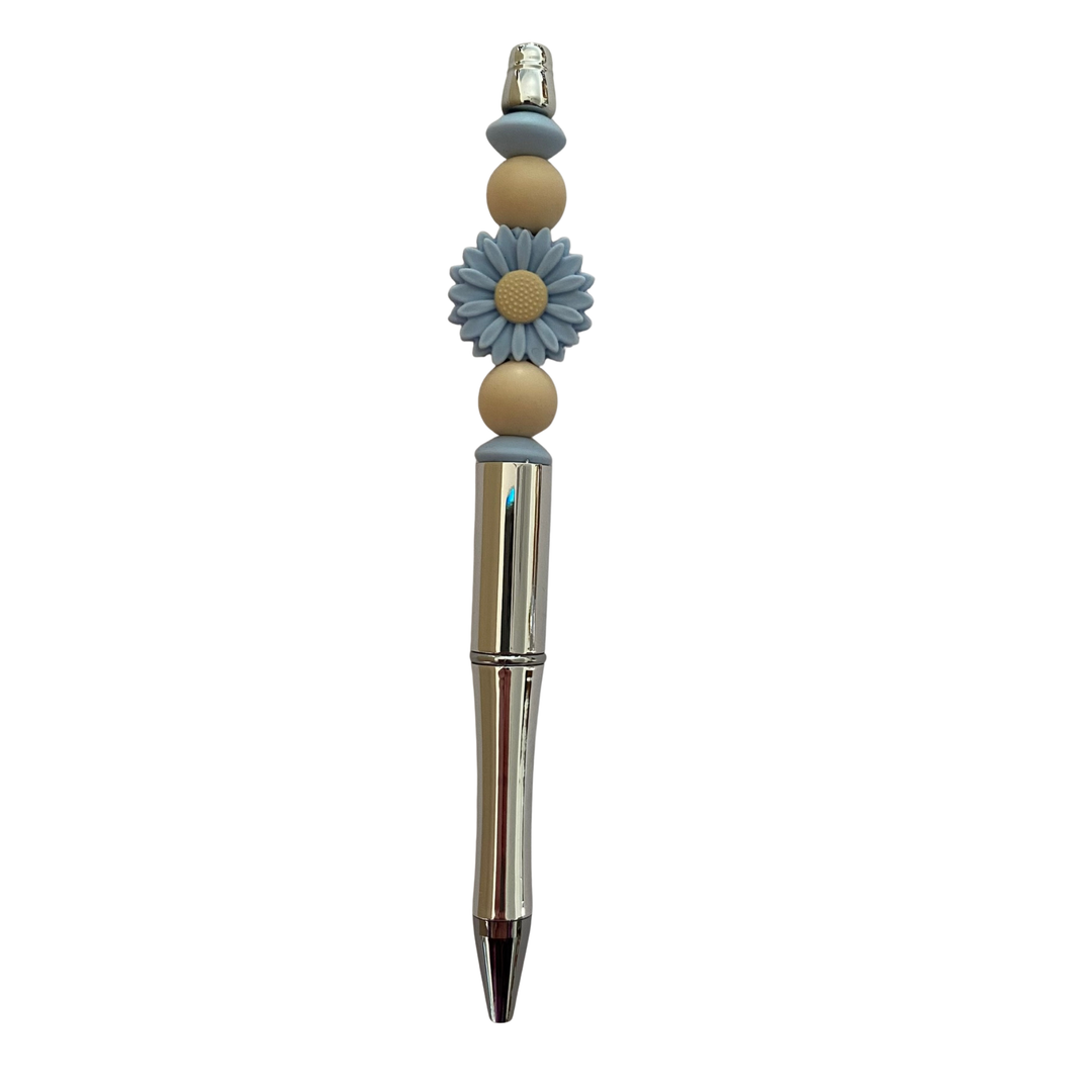 Daisy pen with blue beads on a white background.