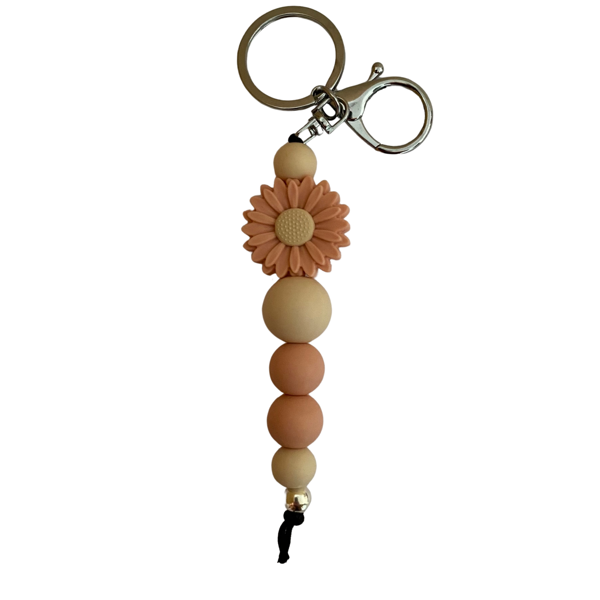 A keyring with a peach daisy silicone bead and other assorted beads.