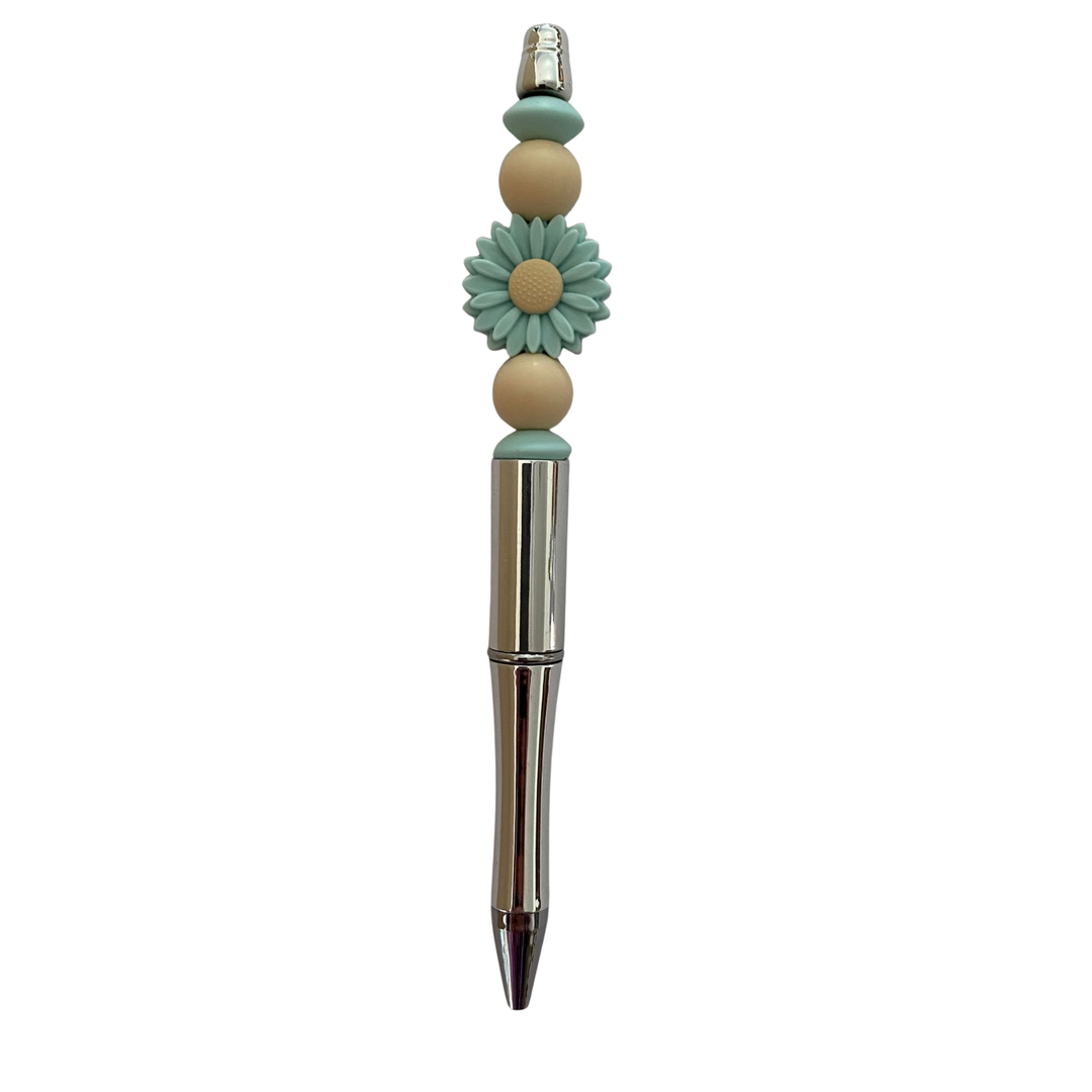 Decorative pen with a aqua daisy flower design on a white background.