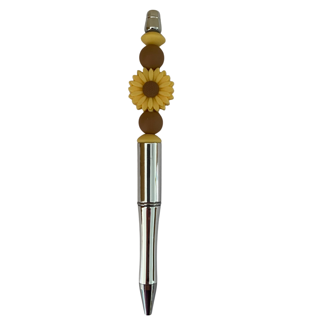Decorative pen with sunflower design on a white background.