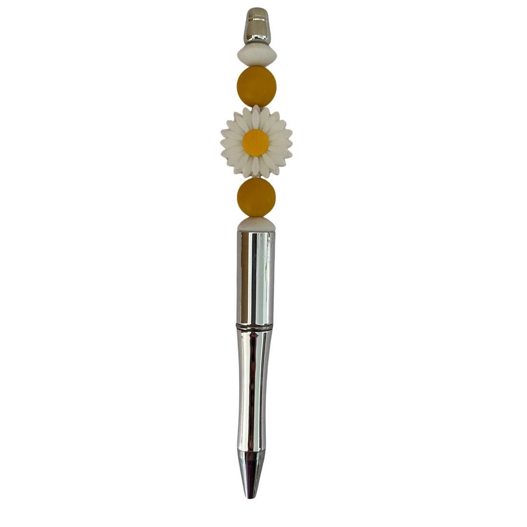 Decorative pen with a daisy white charm on a white background.