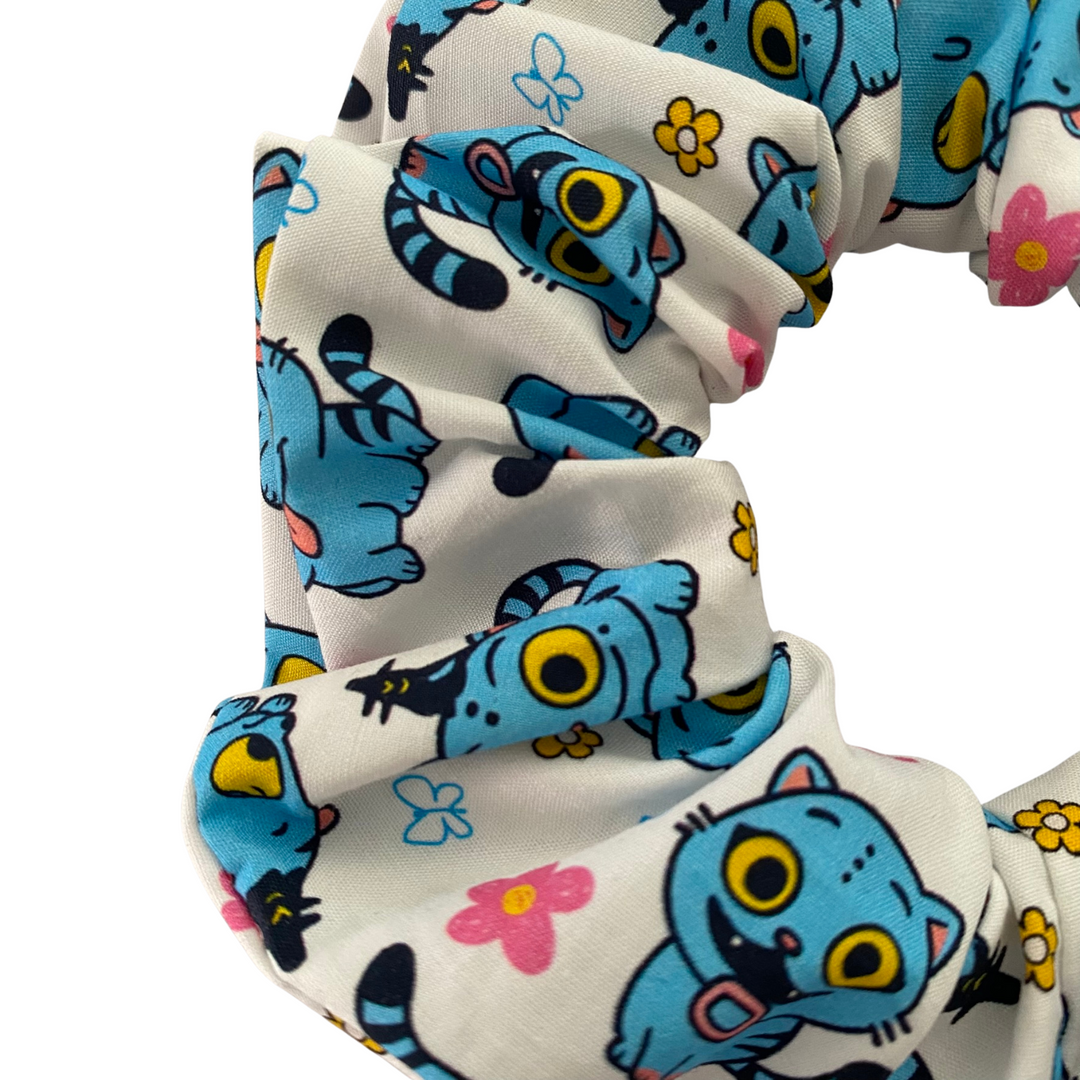 Close up view of images of Derpy Tiger from K-Pop Demon Hunters on a white scrunchie.