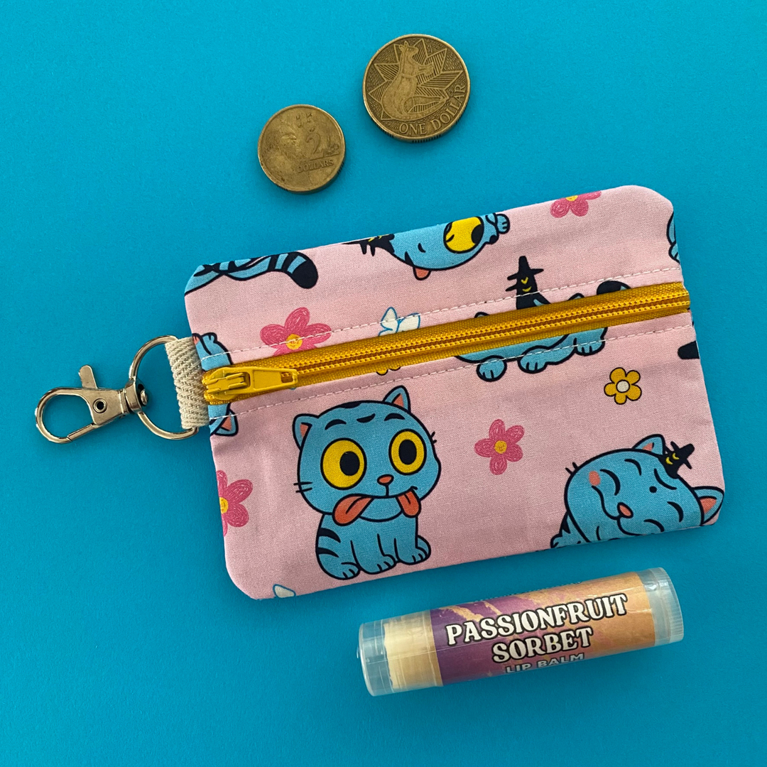 Derpy Tiger from K-Pop Demon Hunters featured on a light pink coin purse with clasp.