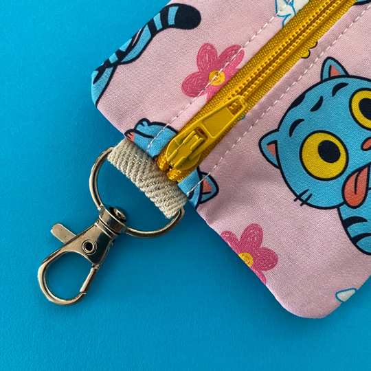 Clasp view of Derpy Tiger from K-Pop Demon Hunters featured on a light pink coin purse with clasp.