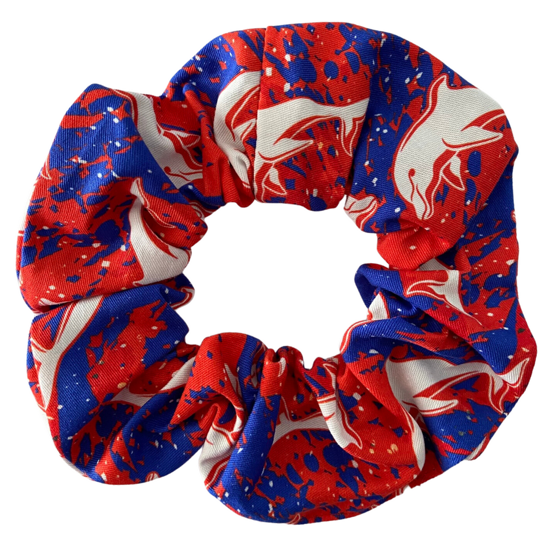 A scrunchie hair tie handmade with cotton woven fabric with images of the Dolphins rugby league team.