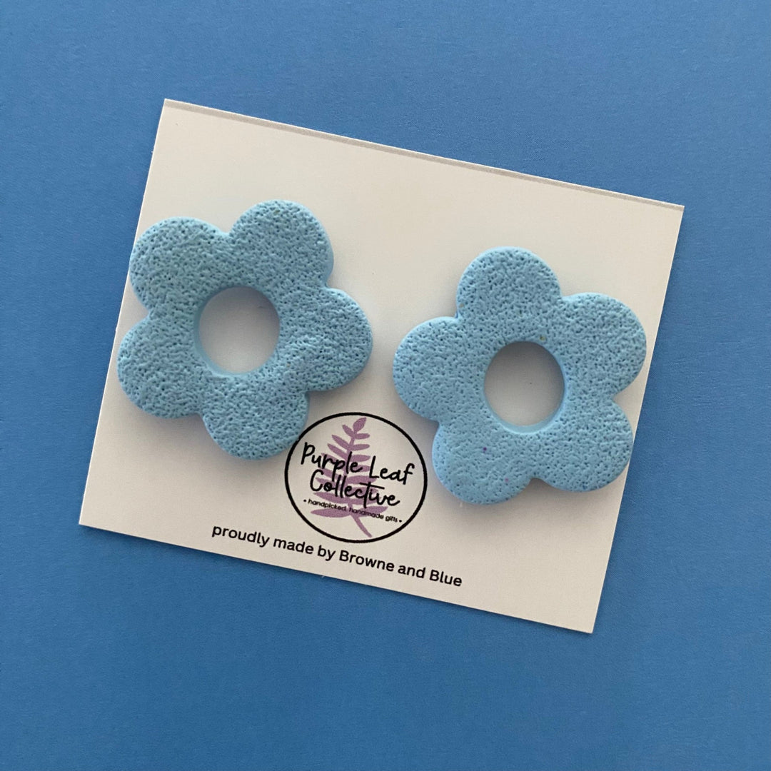 Drop stud earrings with five dusky blue polymer clay flower petals, set on surgical steel posts for comfort and durability.