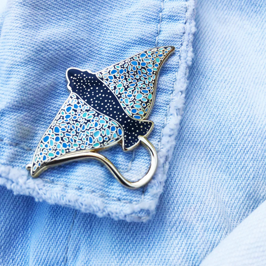 A picture of the Eagle Ray Enamel Pin on a denim jacket.