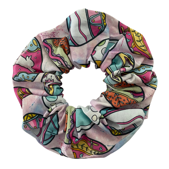 Colourful scrunchie with pastel Easter eggs on a light pink fabric.
