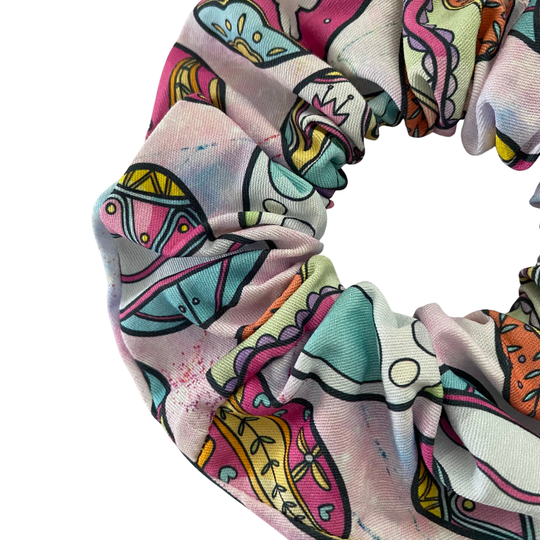 Colourful pastel Easter Eggs scrunchie on a light pink fabric.