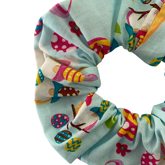 Blue fabric scrunchie with images of Easter Gnomes and patterned Easter eggs.