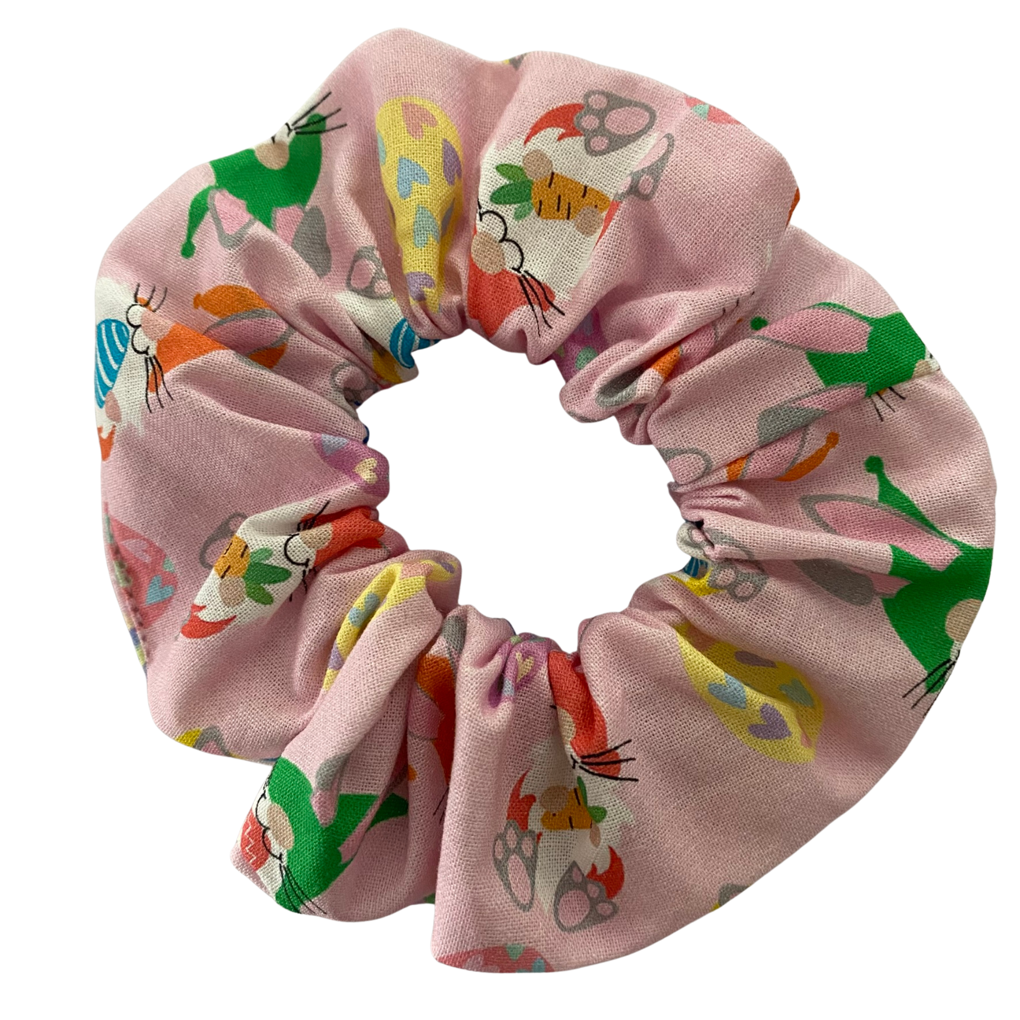Scrunchie with images of Easter Gnomes and patterned Easter eggs on a pink fabric.
