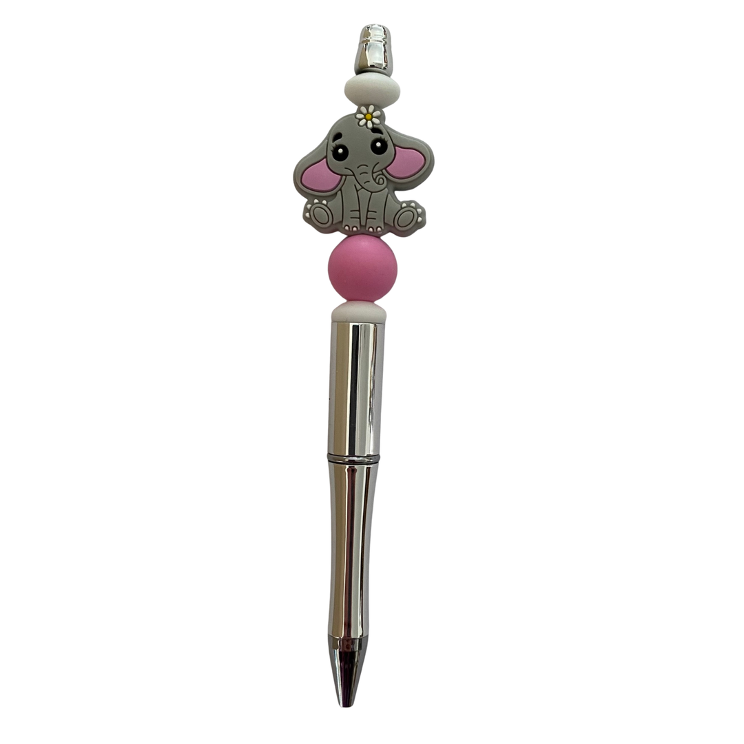 Pen with a elephant silicone bead on top on a white background.
